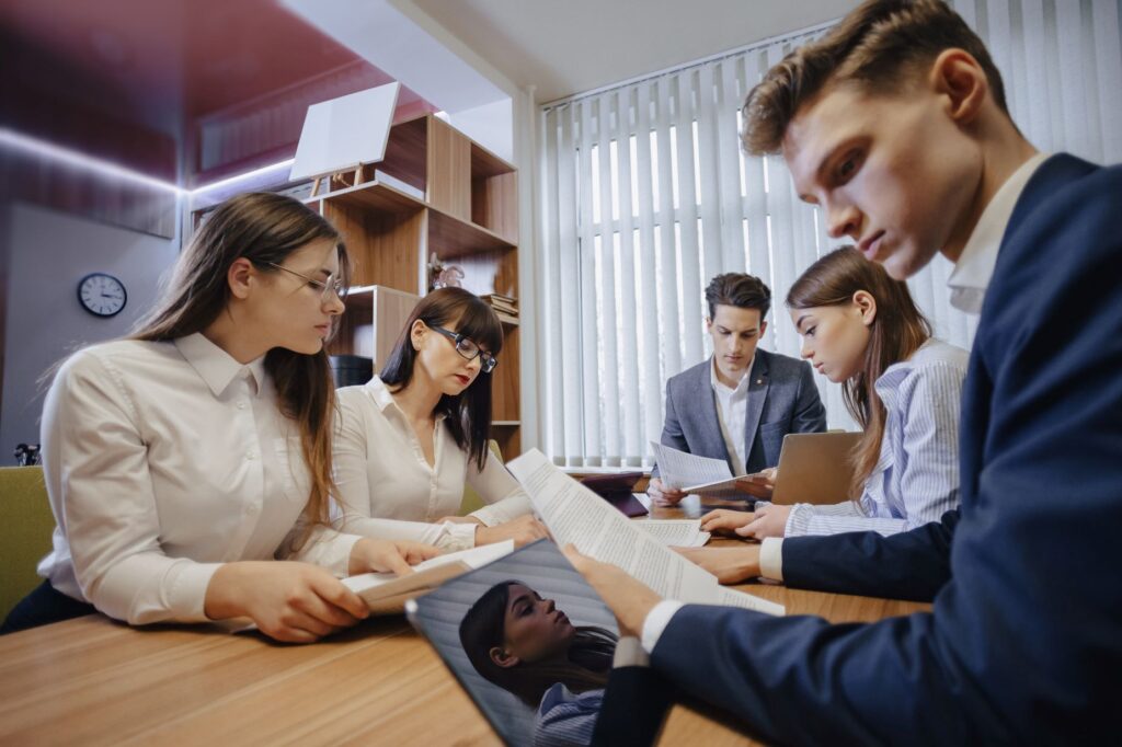 A group of MBA students in a business meeting, discussing strategies and leadership skills, highlighting the advantages of an MBA for career growth.